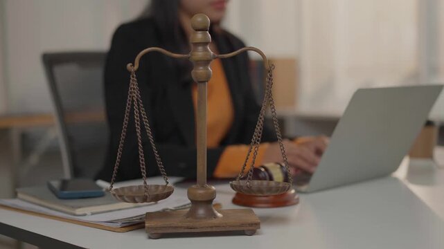 Lawyer working in office with scales of justice