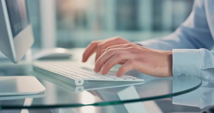 Hands typing on keyboard in office creating digital content on computer