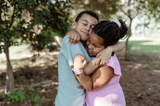Young mixed race siblings playing outdoors