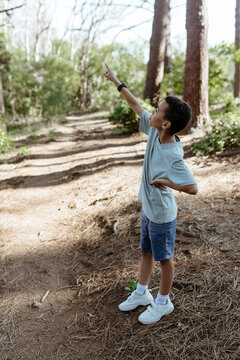 Young mixed race boy pointing while hiking