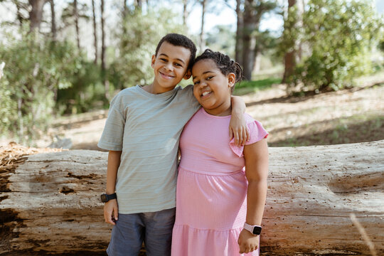 Young mixed race siblings playing outdoors