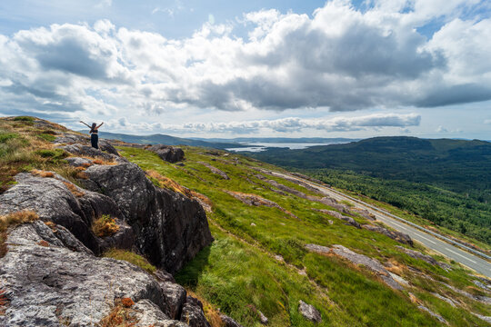 Woman celebrating success on a mountain top in ireland