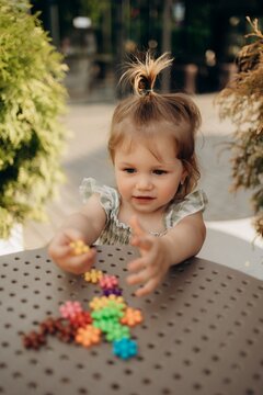 Toddler reaching for colorful educational toys during sensory play