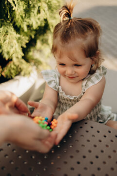 Toddler receiving colorful sensory toys during educational outdoor