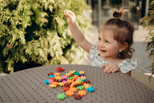 Toddler holding sensory ring during outdoor learning activity