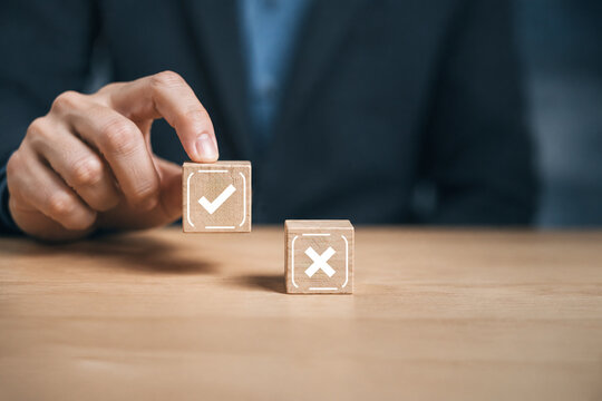 
Businessman is thinking and making choices right from wrong symbols. Decide to vote accept or not. Yes or No decisions, business options in difficult situations. True False, crisis decision making.
