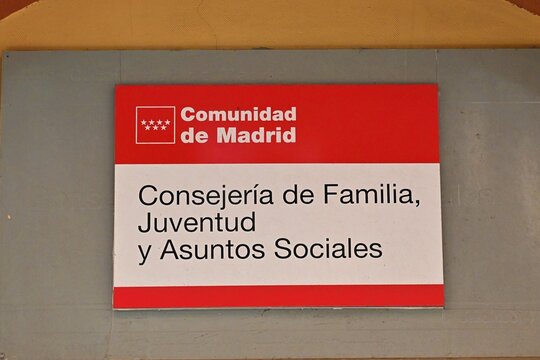 Information sign of the Ministry of Family, Youth and Social Affairs of the Autonomous Community of Madrid, placed on the facade of an administrative building in Madrid, Spain.July 28, 2026