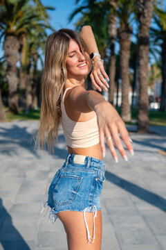 Young woman dancing happy enjoying summer sunshine outdoors