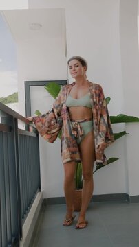 Close up of woman wearing luxury kimono robe over  swimsuit.