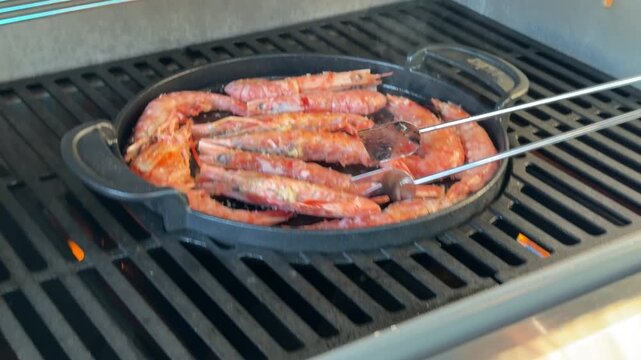 Close-up of grilling red prawns on a barbecue pan