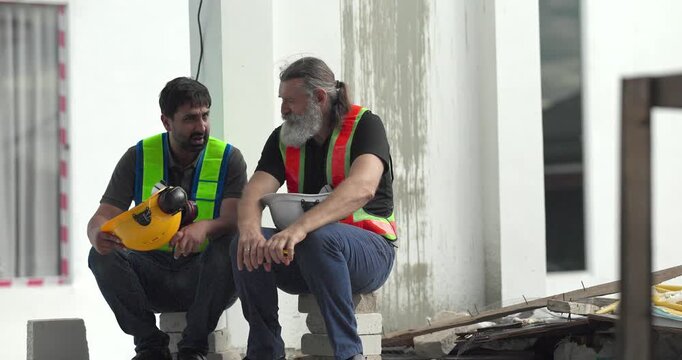  Exhausted construction workers with burnout resting tired and stressed at house building site