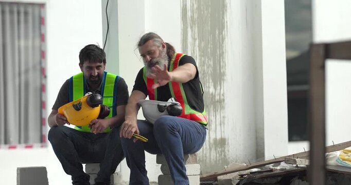  Exhausted construction workers with burnout resting tired and stressed at house building site