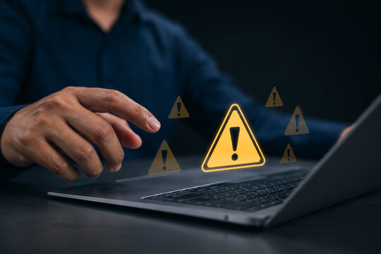 System hacked warning alert. Ransomware, Virus, Spyware, Malware or Malicious software, Data breach, Cyber security and cybercrime. Businessman use laptop with warning sign for cyber attack.