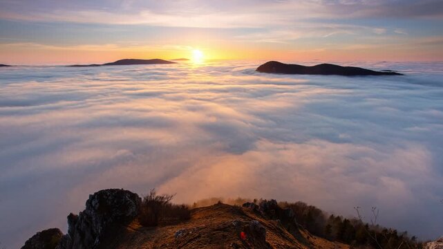 Time lapse of Colorfull sunset behind Mountain peak landscape above clouds - panorama