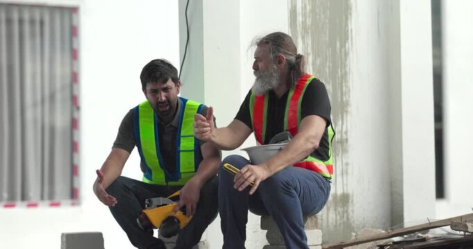  Exhausted construction workers with burnout resting tired and stressed at house building site