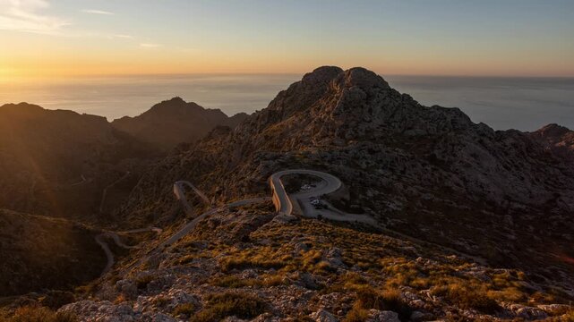 Time lapse of Sunset in spanish mountain panorma with road in Sierra de Tramontana Coll dels Reis, island of Mallorca