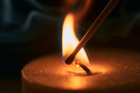photorealistic macro shot of a lit wooden match slowly touching the wick of a candle. the flame barely touches the wick as the candle is lit.
