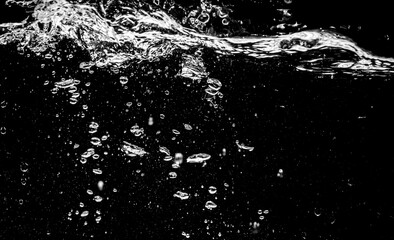 Close-up of bubbling water surface with splashes and a dark background, creating a dynamic abstract effect ©  2026stockx
