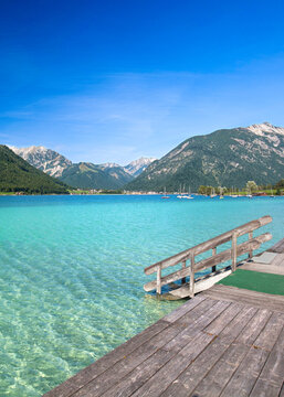 Turquoise Alpine Lake with a Scenic Wooden Stairway in Summer
