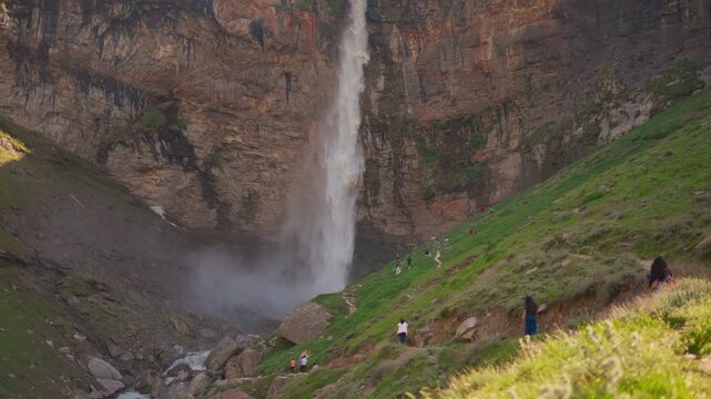 4K Slow motion shot of Sissu waterfall falling from a mountain cliff during the summer season near Sissu village in Lahaul and Spiti district, Himachal Pradesh, India. Scenic natural background.