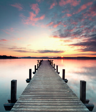 Old Wooden Jetty Leading into a Tranquil Lake at Dawn