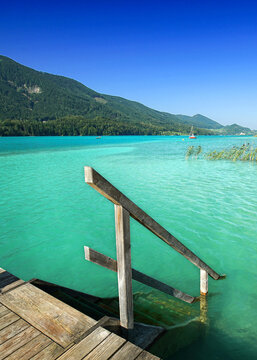 wooden stairway to the turquoise lake