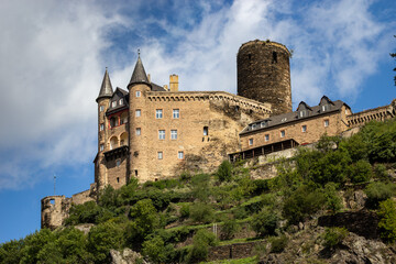 Low angle view of historic Burg Katz castle sitting atop a rocky forested hill along the Rhine River in Germany © Chris Jones