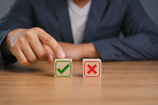 Businessman is thinking and making choices right from wrong symbols. Decide to vote accept or not. Yes or No decisions, business options in difficult situations. True False, crisis decision making.