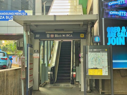 Jakarta, Indonesia - July 17, 2026: An entrance of Blok M BCA MRT Station featuring an escalator, station signage, and a public transport information board.