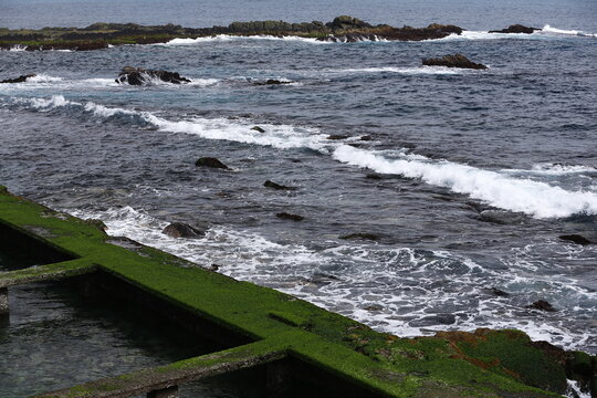 Ocean Waves Break Across a Rocky Shoreline.