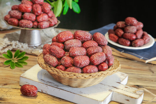 Dried Red Jujubes from Ruoqiang Xinjiang in Wicker Baskets on Wooden Table