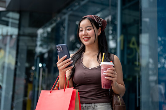 Asian Woman Texting on Phone Outside Shopping Mall