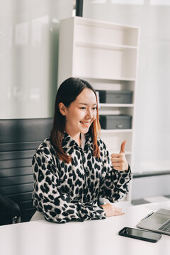 Confident asian business woman standing in modern office