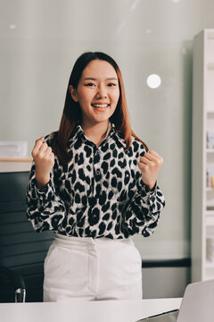 Confident asian business woman standing in modern office