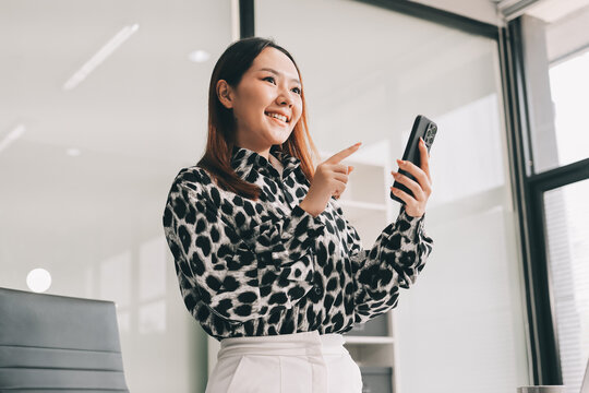 Confident asian business woman standing in modern office