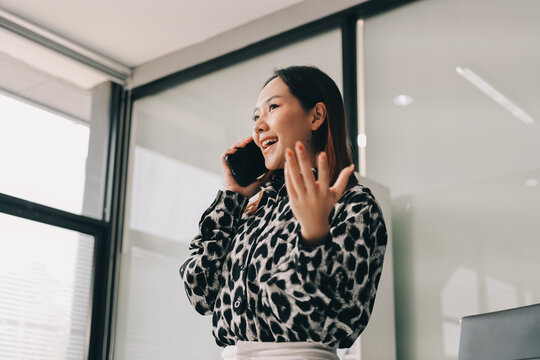 Confident asian business woman standing in modern office