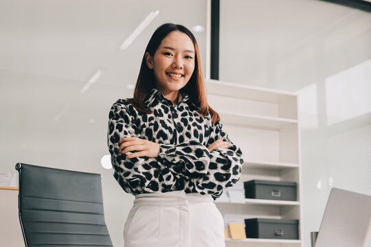 Confident asian business woman standing in modern office
