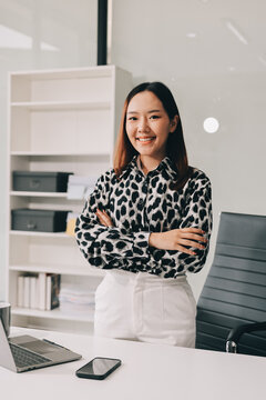 Confident asian business woman standing in modern office