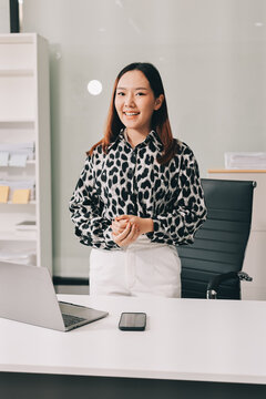 Confident asian business woman standing in modern office