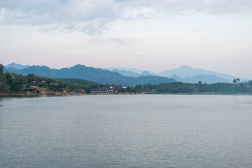 Fototapeta premium Scenic Riverside Floating Houses Near Mon Bridge (Uttamanusorn Bridge) in Sangkhla Buri, Kanchanaburi, Thailand