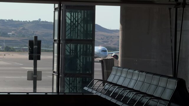 Empty Airport Waiting Area Facing Runway Through Large Window