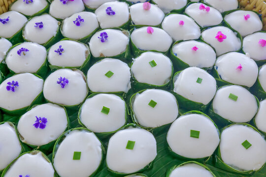 Traditional Thai Coconut Pudding Khanom Tako in Banana Leaf Cups.hanom Tako, a traditional Thai dessert featuring a sweet layer of taro and water chestnut topped with creamy white coconut milk curd