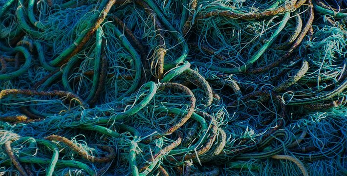 Fishing nets and ropes texture and pattern on a fisherman's boat in a Mediterranean city, nautical equipment background 