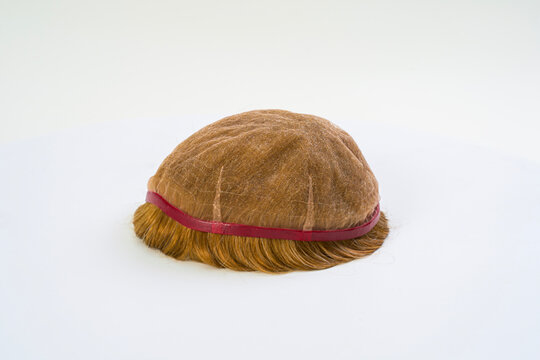 Golden wig on white background