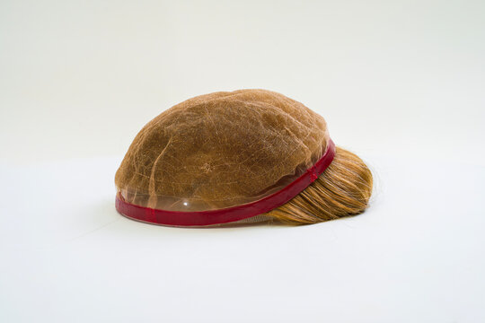 Golden wig on white background