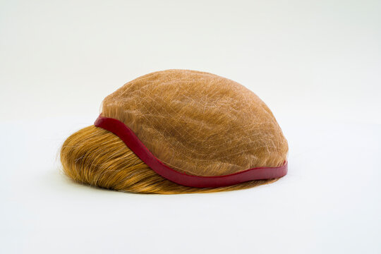 Golden wig on white background