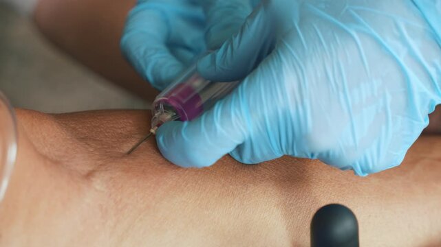 Healthcare Worker Collecting Blood Sample from Elderly Patient