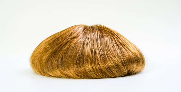 Golden wig on white background