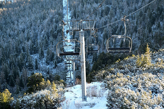 View of a long cable car with cabins in the mountain heights in winter