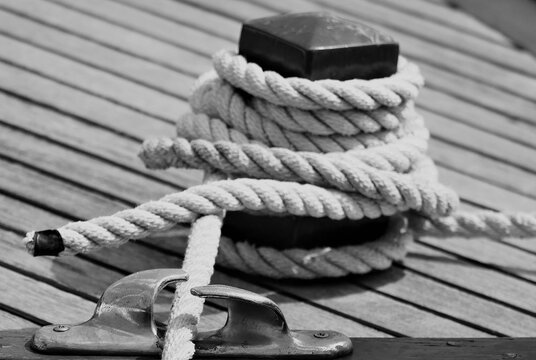 Rope for the boat with rustic texture and pattern by the blue sea, nautical equipment background